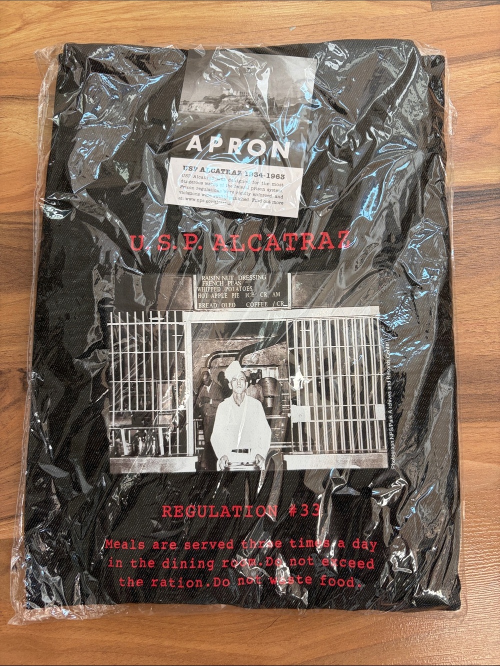 U.S.P. Alcatraz Black Graphic Apron